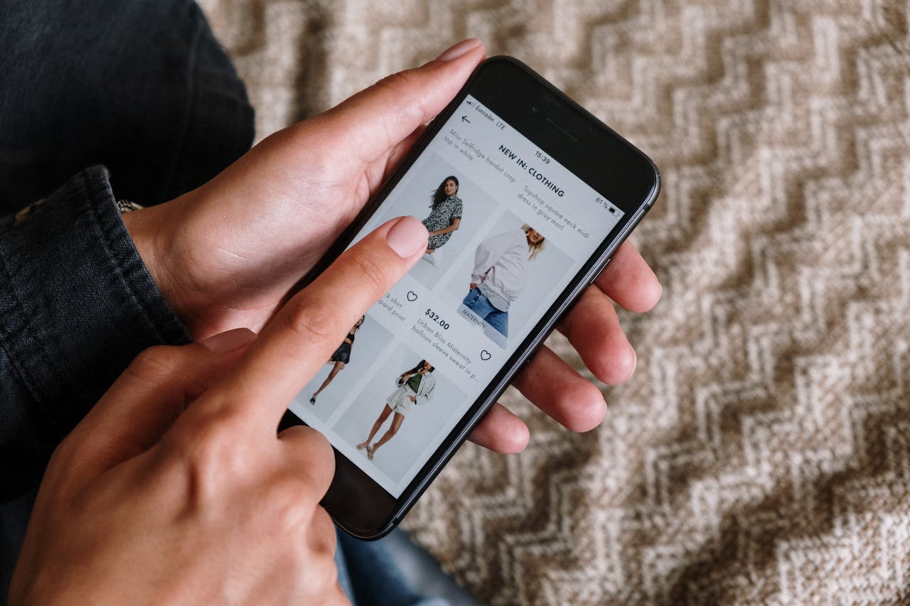 The Art of Drawing Readers In: Your attractive post title goes here Person browsing clothing items on a smartphone, showcasing modern online shopping experience.